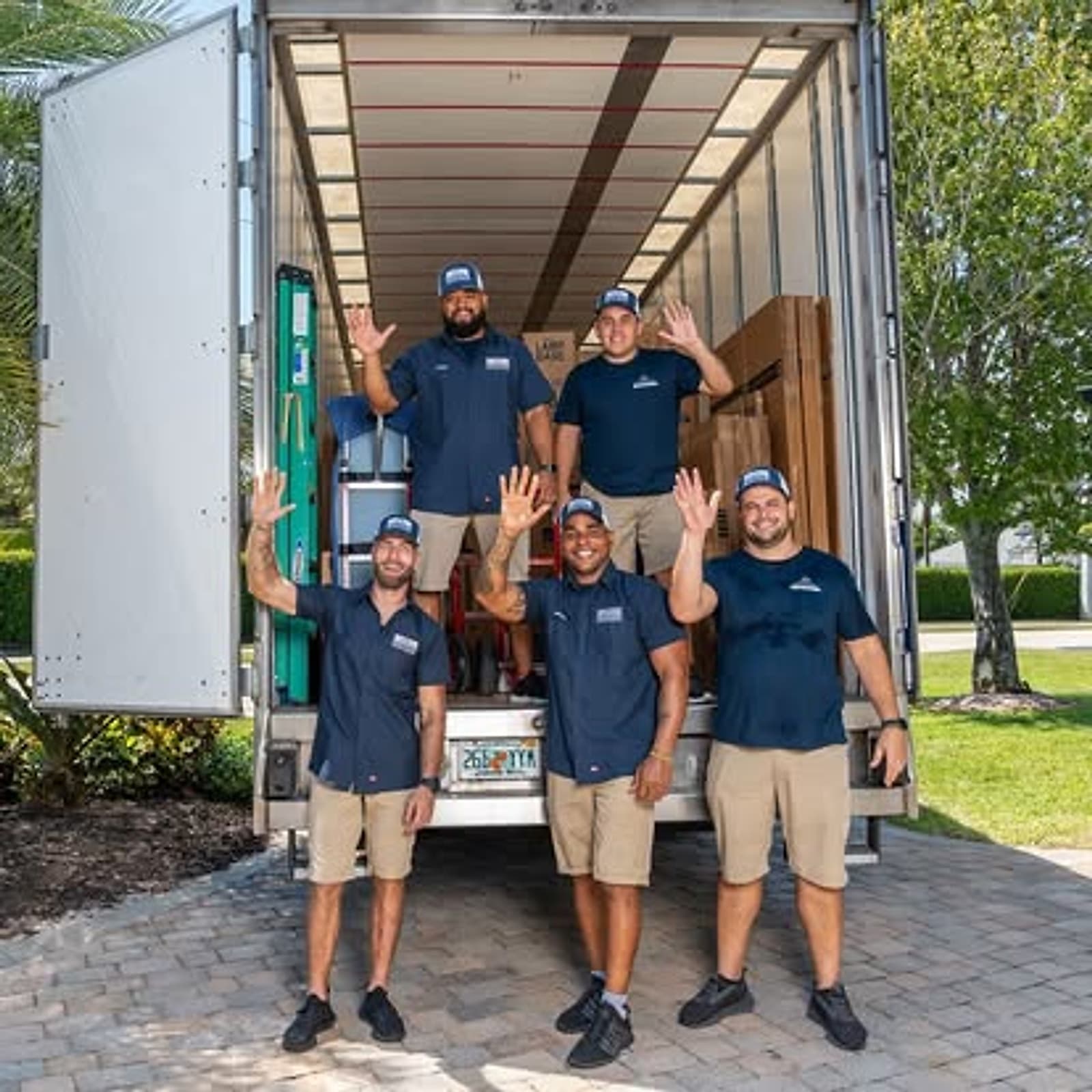 Credo Enterprise movers loading protected furniture and labeled boxes into a moving truck