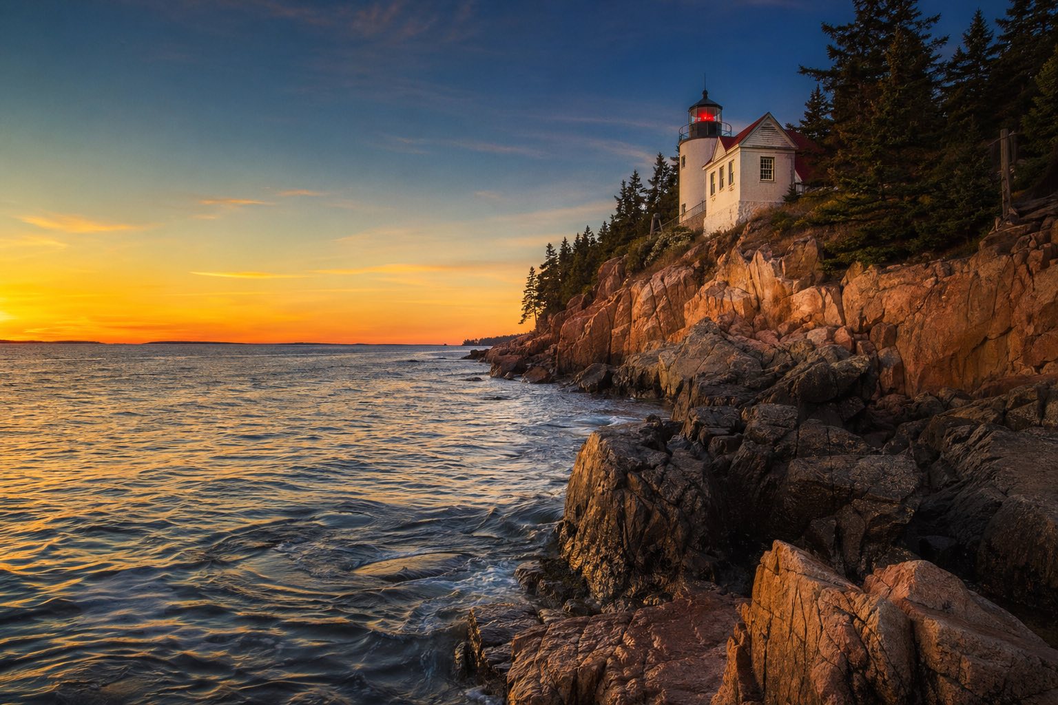 Modern photograph of the Acadia coastline and Bass Harbor lighthouse at sunset representing Credo Enterprise' Maine service area