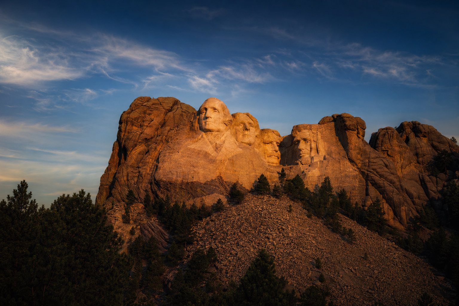 Modern photograph of Mount Rushmore and the Black Hills at sunset representing Credo Enterprise' South Dakota service area